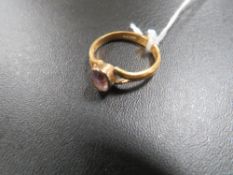 A HALLMARKED 22 CARAT GOLD BAND WITH HAND MADE SPILT SET OVAL AMETHYST approx weight 4.2g RING