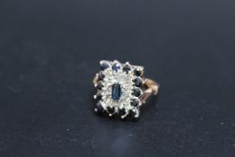 A SAPPHIRE AND DIAMOND DRESS RING, set on an unmarked yellow metal band, ring size K