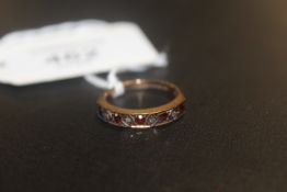 A HALLMARKED 9 CARAT GOLD GEM SET HALF ETERNITY RING SET WITH RUBY AND DIAMOND STYLE STONES approx