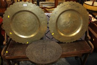 TWO EASTERN BRASS CHARGERS AND A CAST PLAQUE