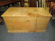 AN ANTIQUE PINE BLANKET BOX