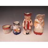 THREE ANTIQUE STAFFORDSHIRE TOBY JUGS, to include Punch and Judy, blue and white example and a