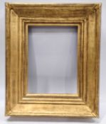 A gilt picture frame of composite construction.