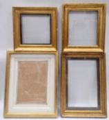 Four glazed gilt picture frames of composite construction.