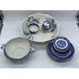 A large collection of blue and white wall plates