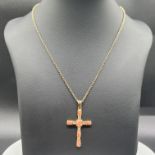 A large 9ct yellow gold coral stone set cross