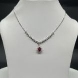 A 14ct white gold Ruby + Diamond necklace