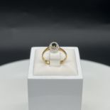 An 18ct yellow gold sapphire + diamond dress ring