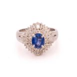 A sapphire and diamond cluster ring, featuring an oval-cut sapphire in vivid blue colour,