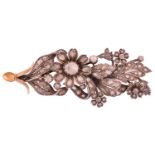 A diamond floral spray brooch, set with mixed rose-cut and flat-cut diamonds, the largest