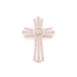 A 9 carat white gold and diamond set cross, the central round panel enclosing three floating