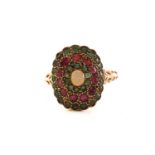 A yellow metal, ruby, emerald, and opal dress ring, centred with an oval cabochon opal, with flush-