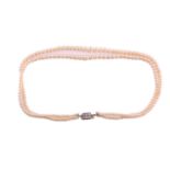 A graduated two-row cultured pearl necklace with a diamond set clasp, the beads from approximately