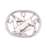 Georg Jensen - A brooch depicting kneeling fawn and flowers, fitted with hinged pin stem and roll-