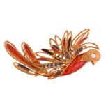 A sapphire and diamond phoenix brooch set in textured yellow metal with translucent orange enamel