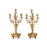 A pair of 19th-century style gilt bronze candelabrum, each with four lights, on a vase shape stems