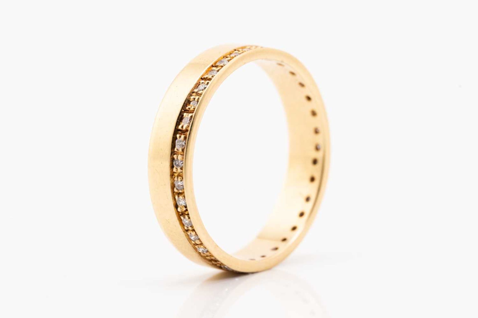 An 18ct yellow gold and diamond wedding band, comprising a flat band pavé-set with a continuous - Image 2 of 5