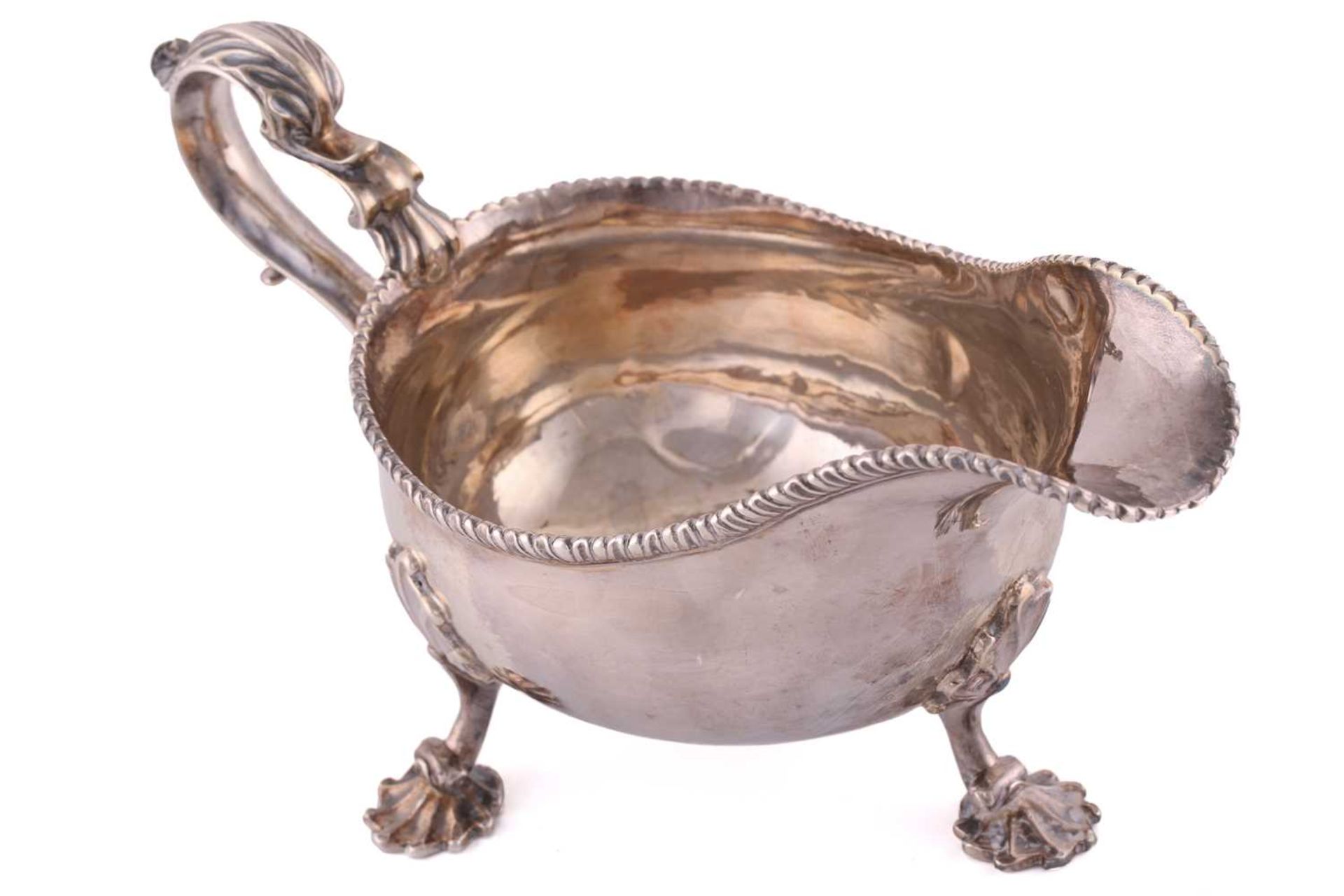 A pair of George II silver sauce boats; with gadrooned borders and leaf capped double scroll - Image 5 of 12