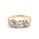 An old-cut diamond trilogy ring, claw-set in coronet mount with a light yellow old-cut diamond and