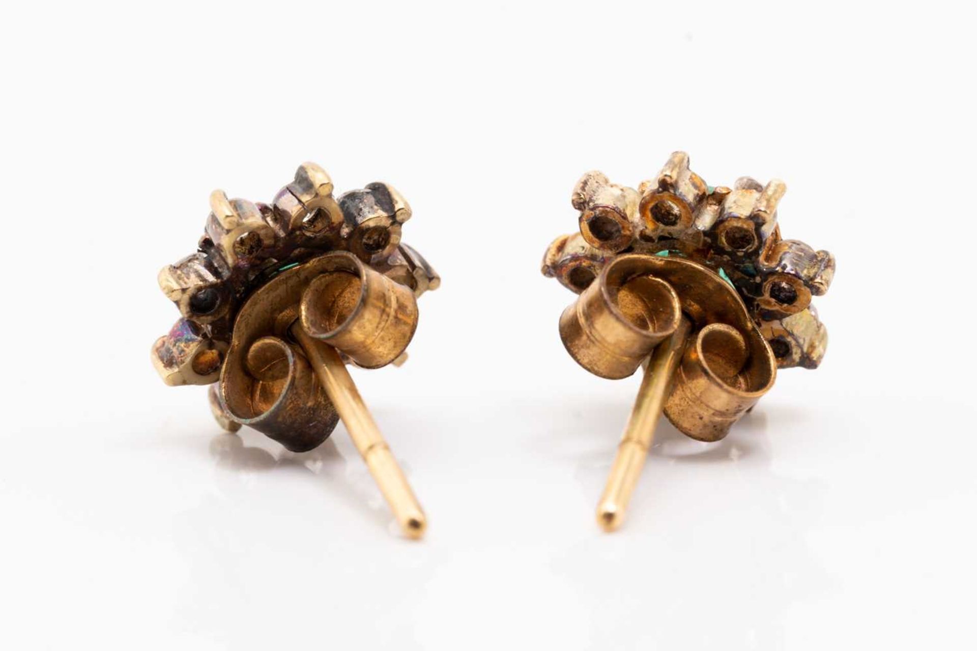 A pair of yellow metal, emerald and diamond earrings, of floral cluster design, each set with a - Image 3 of 3