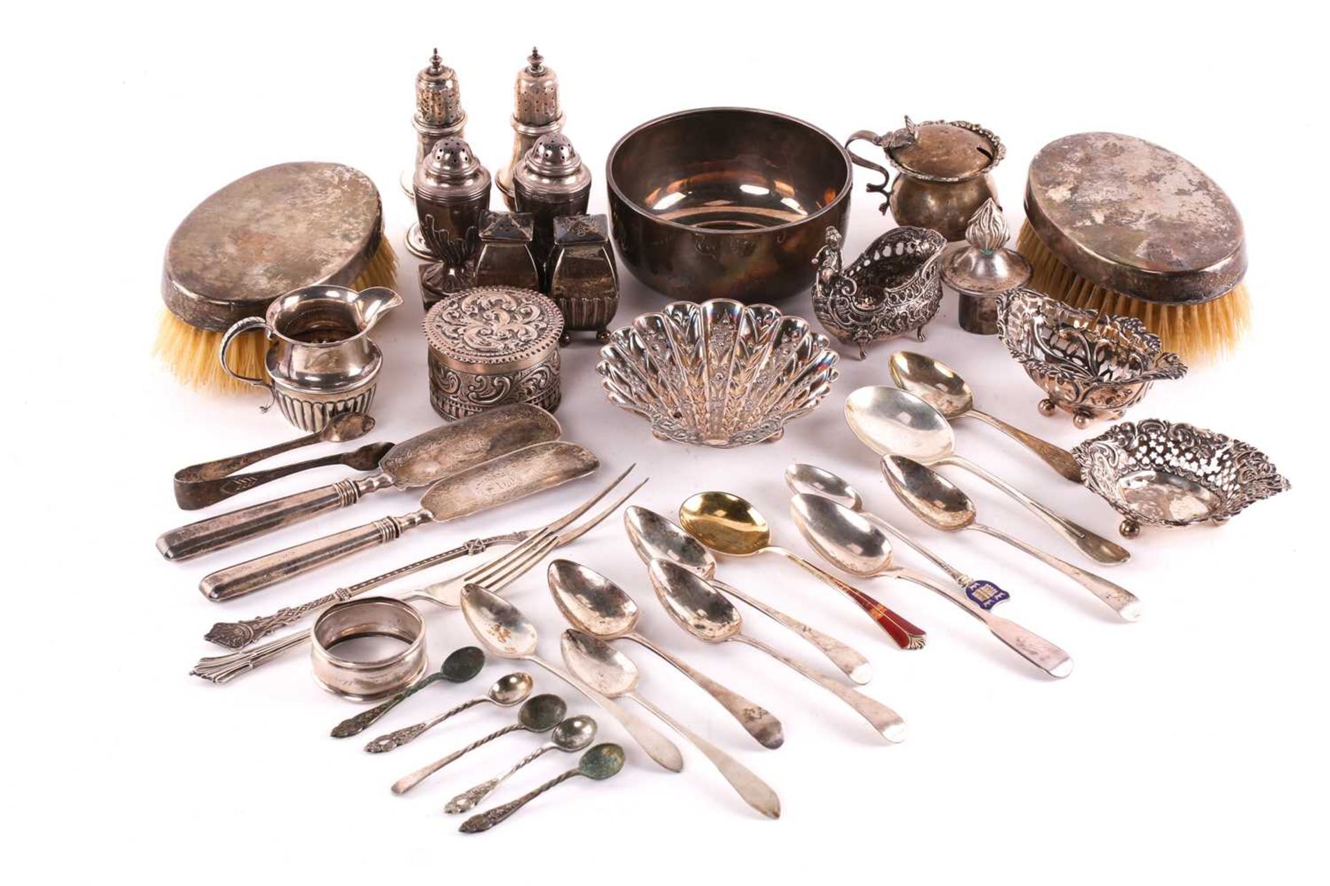 A silver bowl, a pair of silver backed hairbrushes, a silver butter shell, a pair of butter knives