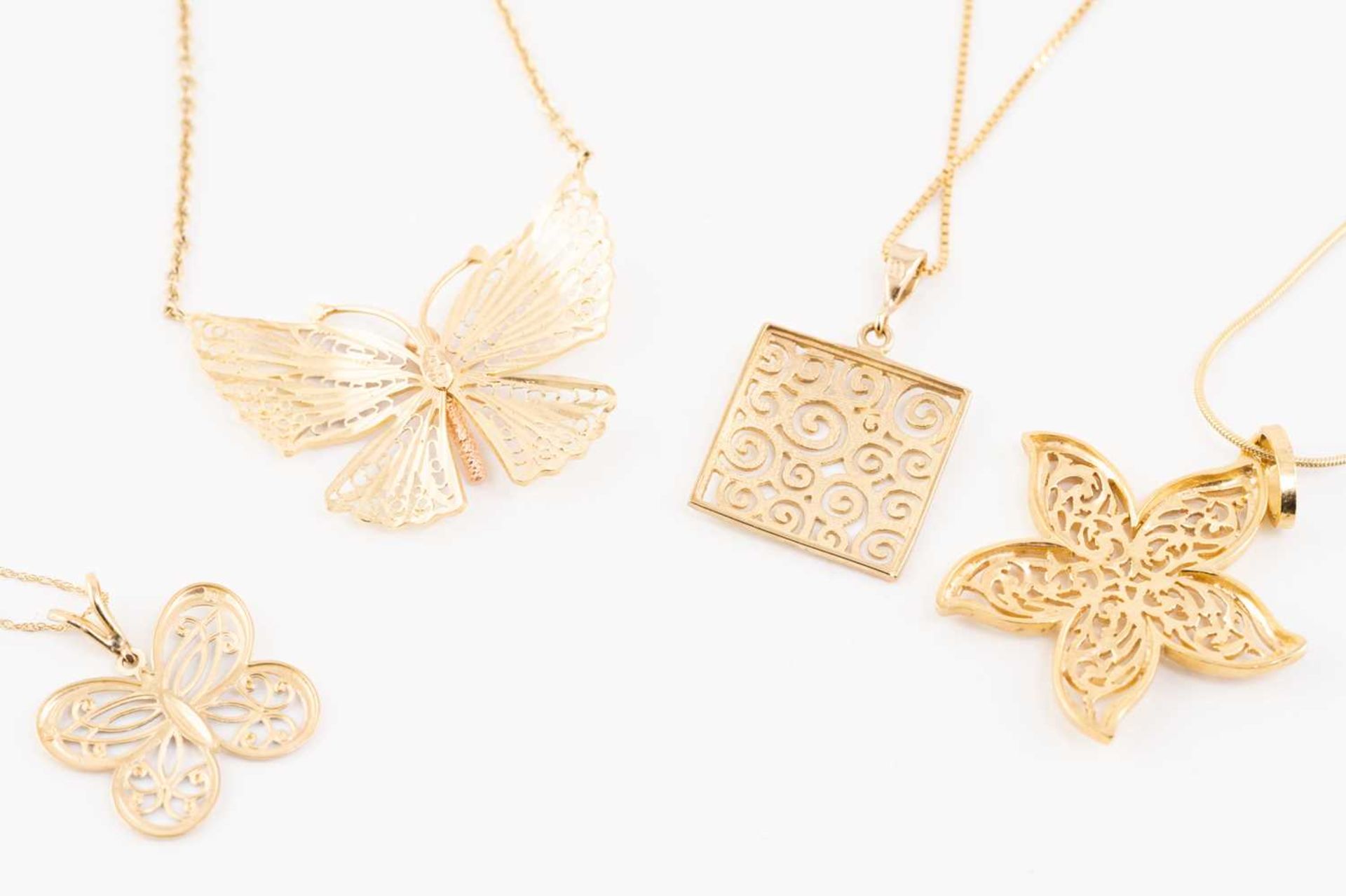 A collection of four pieced-out pendants on chains, including a 10ct gold pierced butterfly - Image 6 of 6