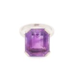 An amethyst solitaire ring, featuring an emerald-cut amethyst of 15.4 x 12.8 x 8.6 mm, corner claw