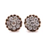 A pair of diamond cluster earrings, each composed of a circular old-cut centre diamond encompassed