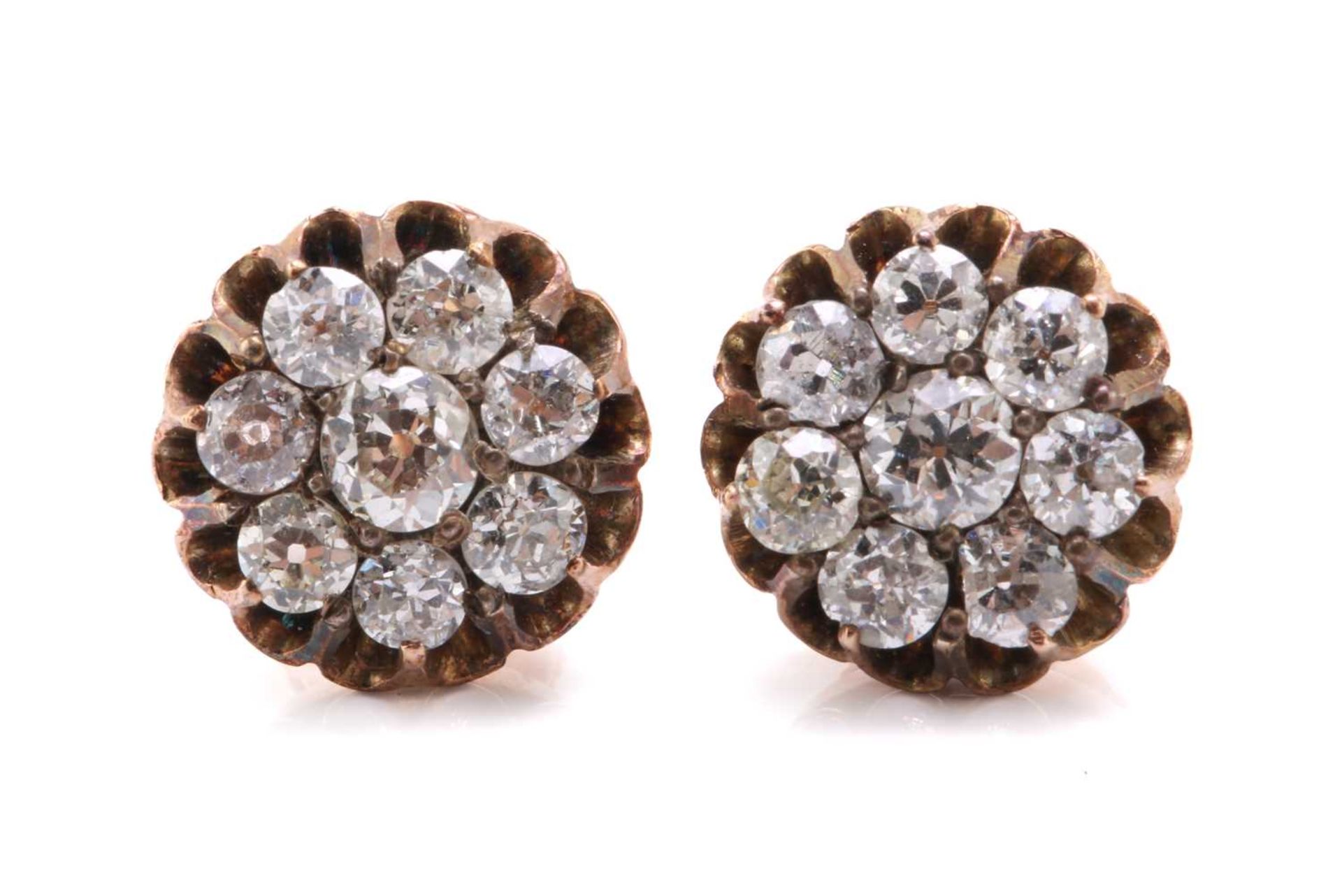 A pair of diamond cluster earrings, each composed of a circular old-cut centre diamond encompassed
