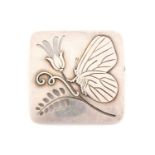 Georg Jensen - A brooch depicting a butterfly on a pierced flowering stem, fitted with hinged pin