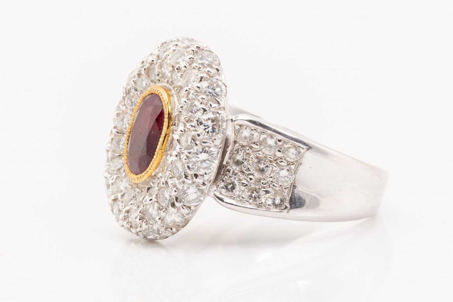 A synthetic ruby and diamond cluster style ring, featuring a rub over set oval cut synthetic ruby - Image 3 of 5