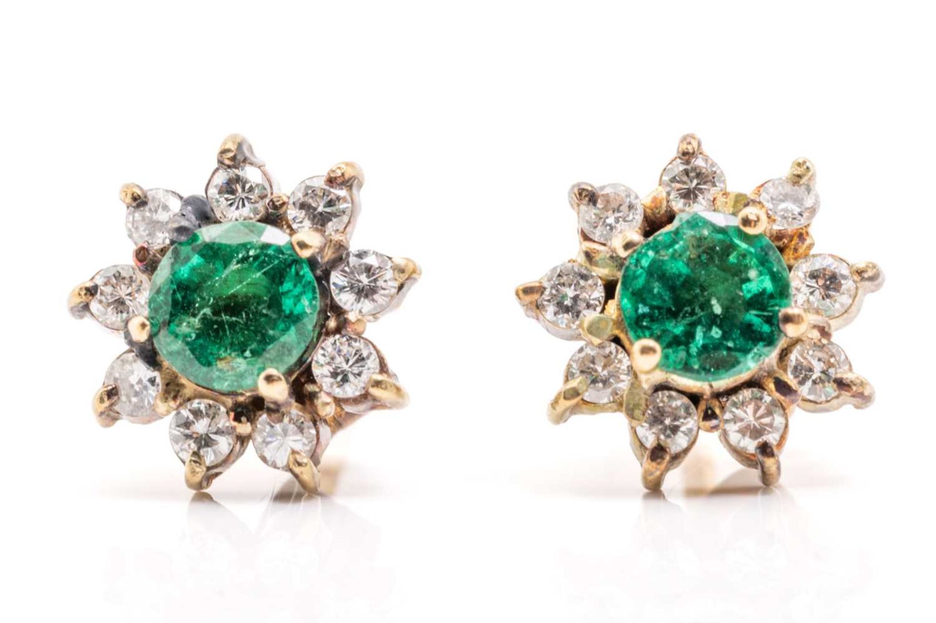 A pair of yellow metal, emerald and diamond earrings, of floral cluster design, each set with a
