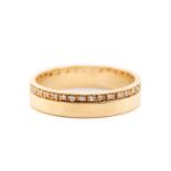 An 18ct yellow gold and diamond wedding band, comprising a flat band pavé-set with a continuous