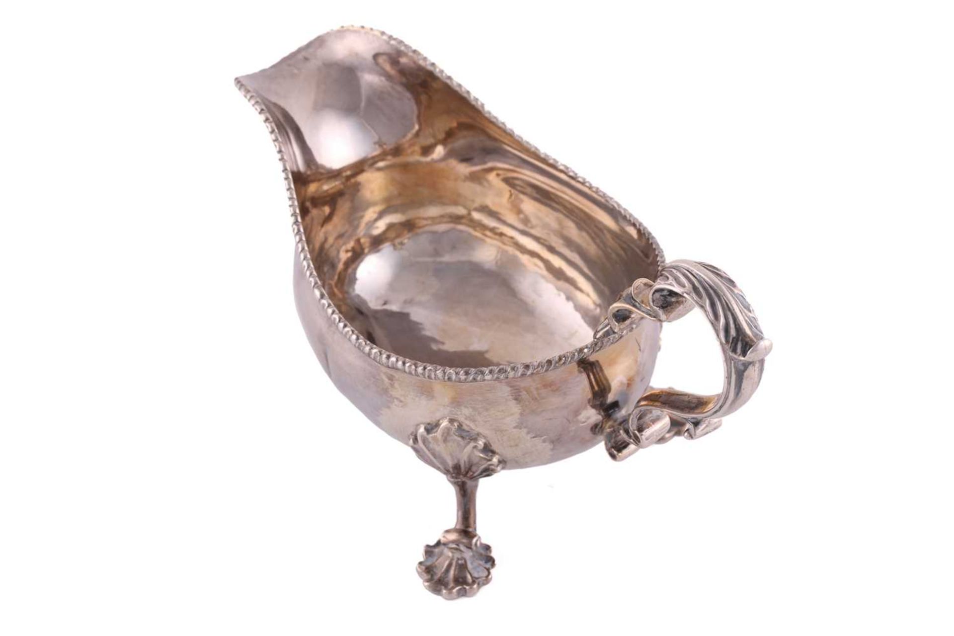 A pair of George II silver sauce boats; with gadrooned borders and leaf capped double scroll - Image 3 of 12