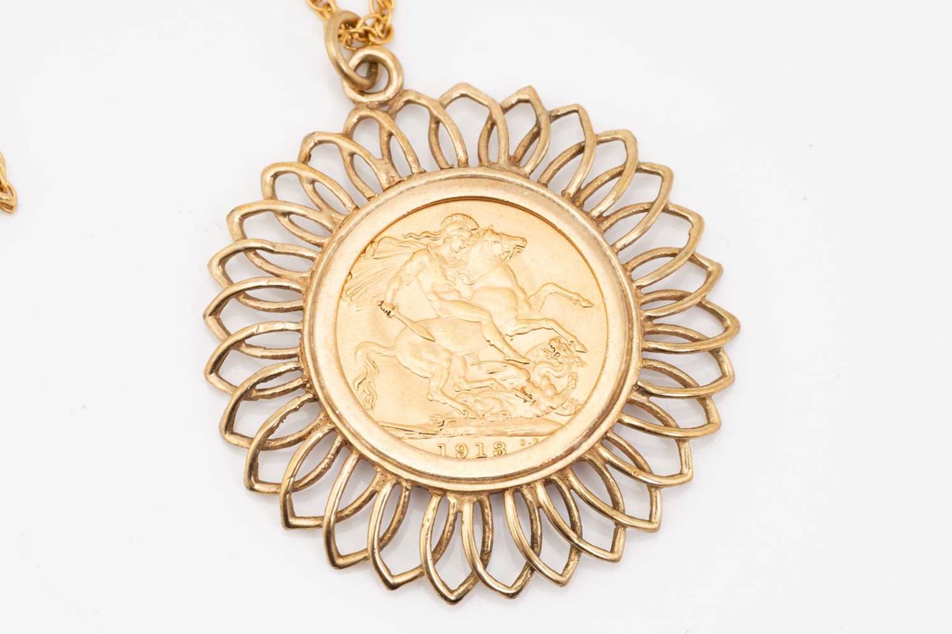 A sovereign pendant on chain; the sovereign dated 1913, in 9 carat gold openwork mount; to an - Image 2 of 4