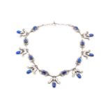 Georg Jensen - A necklace set with lapis lazuli cabouchon, connecting to a toggle and ring clasp No.