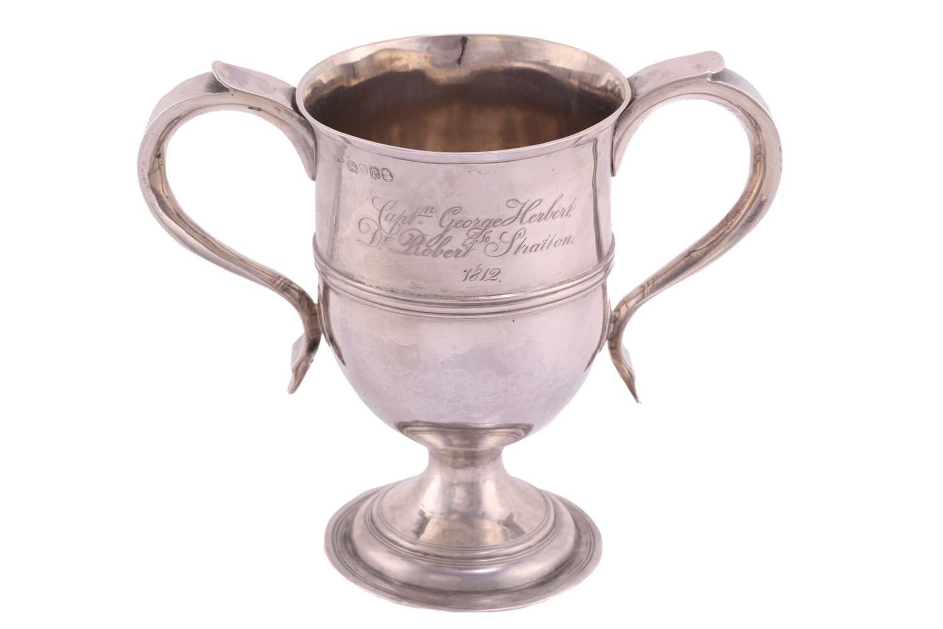 A George III two handled cup; inverted bell shape with hollow side handles and central reeded