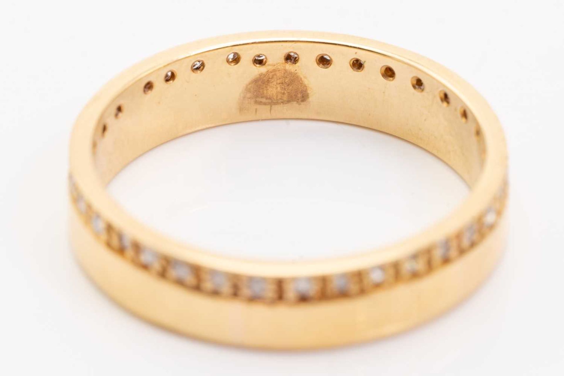 An 18ct yellow gold and diamond wedding band, comprising a flat band pavé-set with a continuous - Image 4 of 5