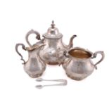A Victorian silver three-piece tea service and sugar tongs of mixed date but the corresponding