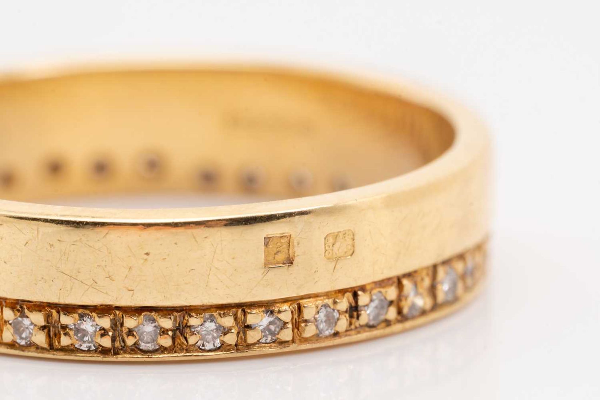 An 18ct yellow gold and diamond wedding band, comprising a flat band pavé-set with a continuous - Image 3 of 5