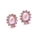 A pair of pearl and cubic zirconia cluster earrings in high-carat gold, each features an oval-shaped