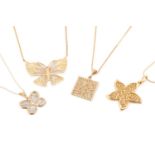 A collection of four pieced-out pendants on chains, including a 10ct gold pierced butterfly