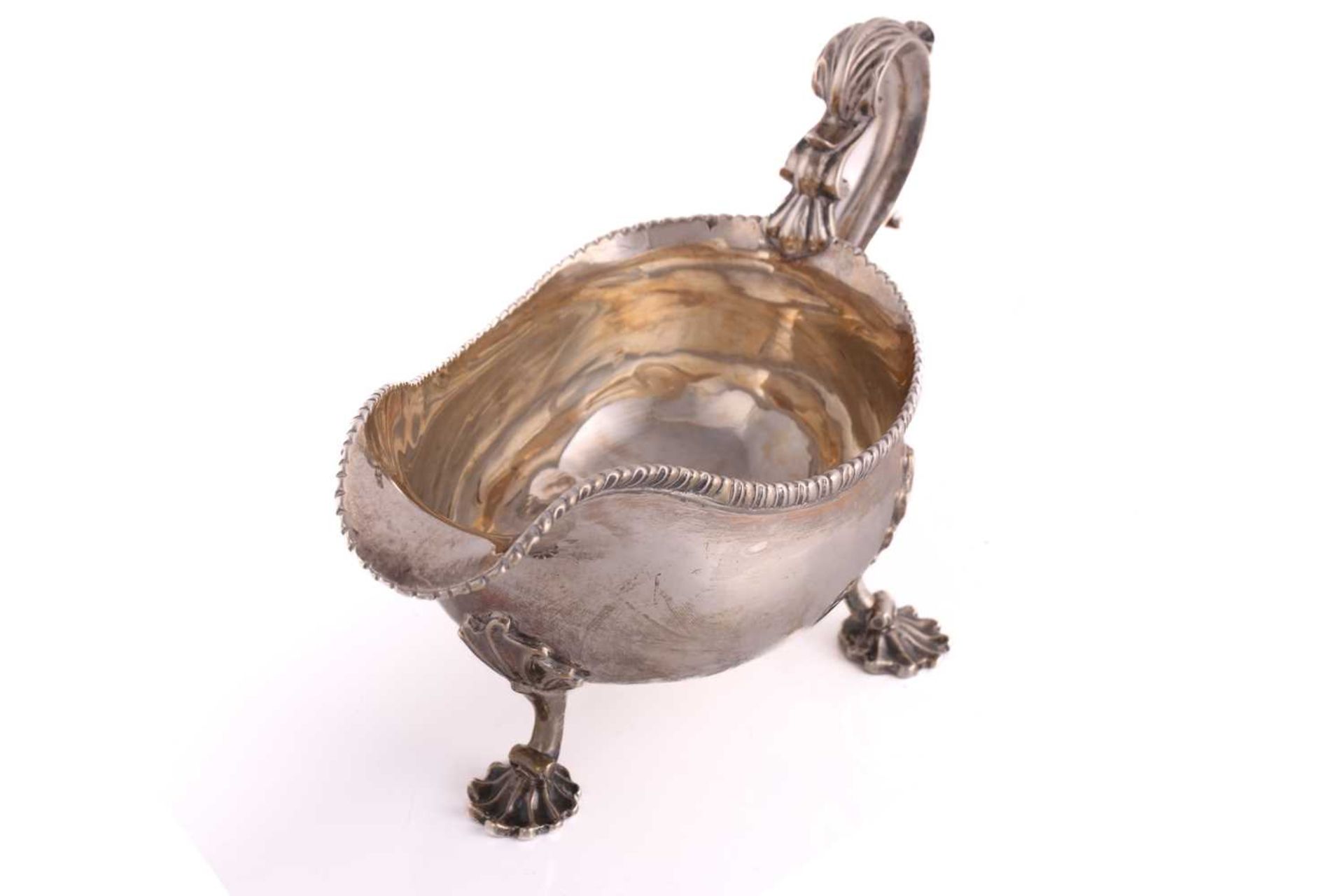 A pair of George II silver sauce boats; with gadrooned borders and leaf capped double scroll - Image 9 of 12
