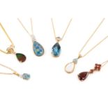Six gem-set drop pendants on chains; including an ammolite triplet and diamond pendant in 14ct