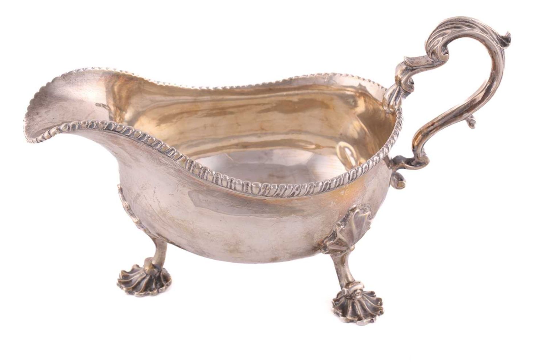 A pair of George II silver sauce boats; with gadrooned borders and leaf capped double scroll - Image 11 of 12