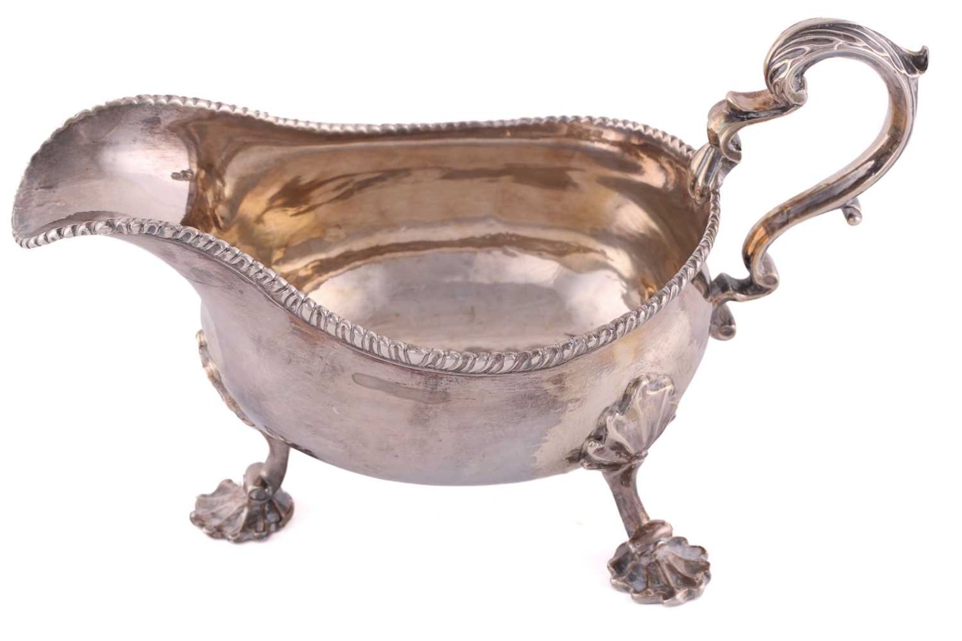 A pair of George II silver sauce boats; with gadrooned borders and leaf capped double scroll - Image 4 of 12