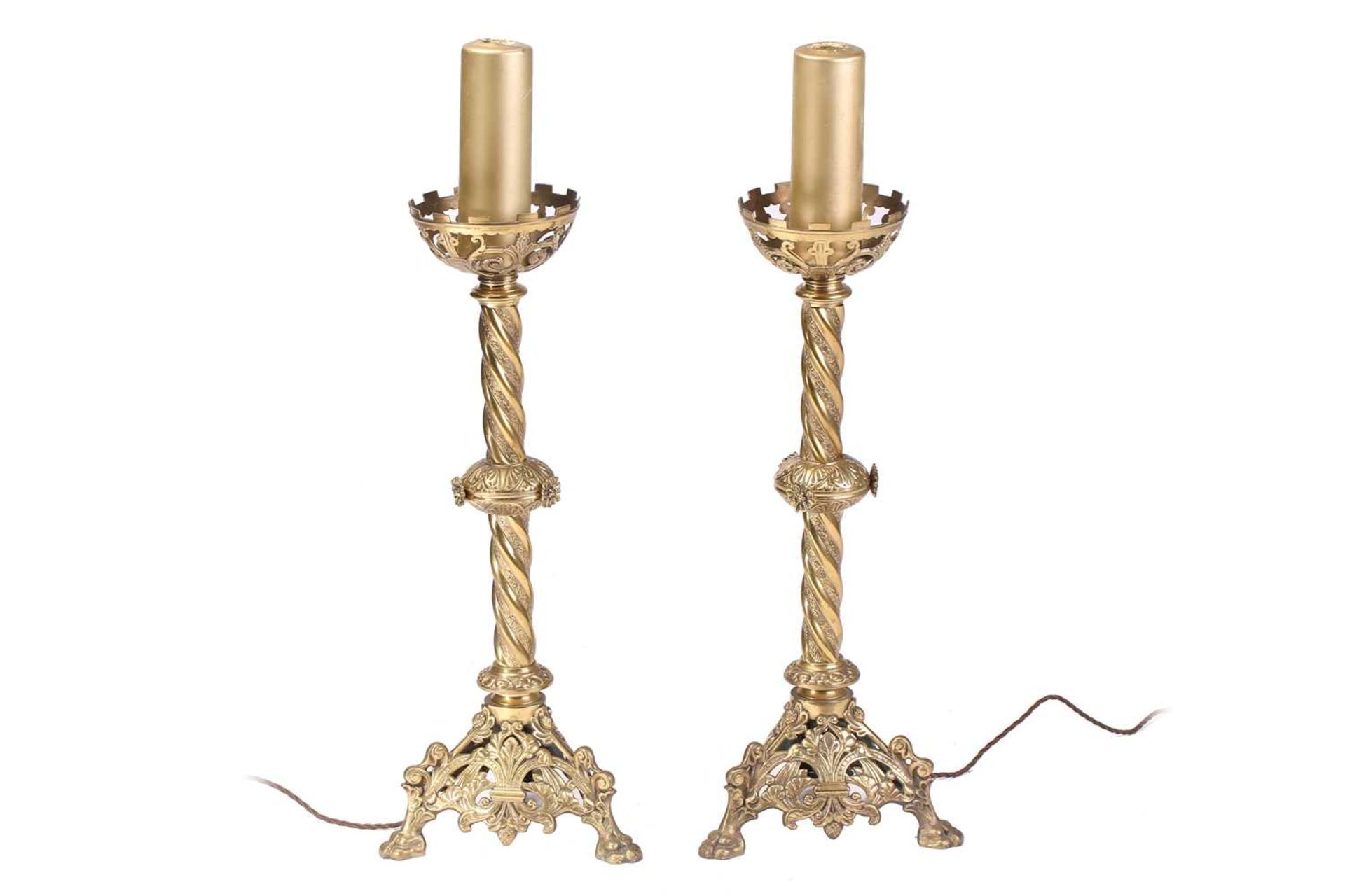 A pair of 19th-century "Ecclesiastic- Gothic" gilt brass table lamps with pierced cup drip pans