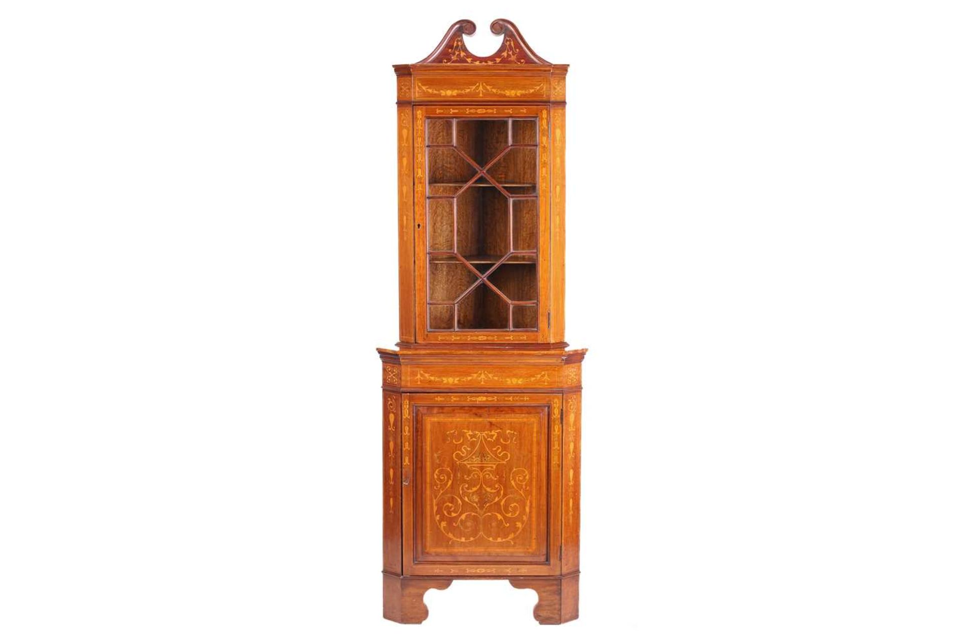 An Edwardian mahogany and Neo-Classical marquetry inlaid freestanding corner display cabinet, in the