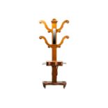 A Victorian golden oak "tree" hall stand with four shaped branches and turned hat and coat pegs