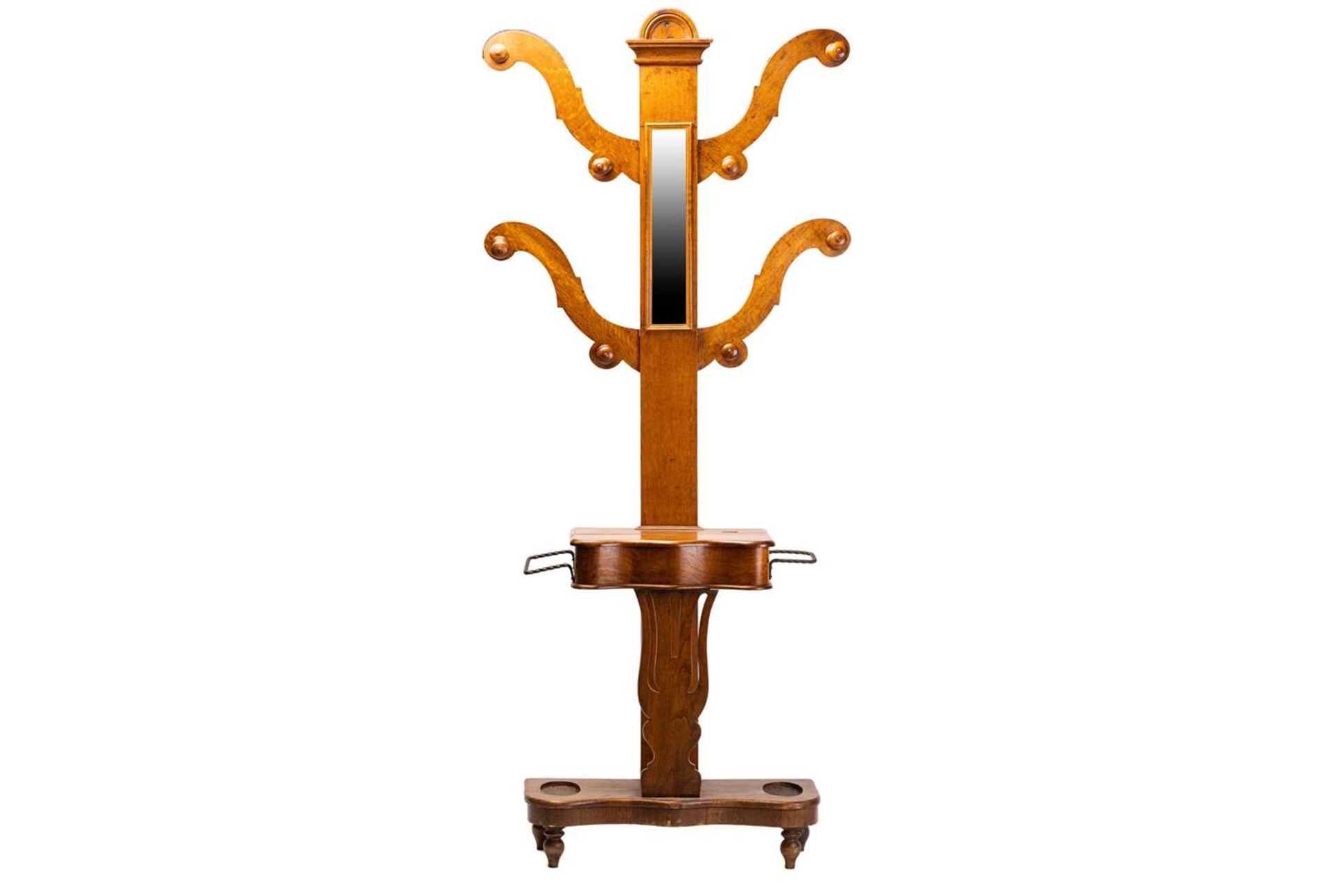 A Victorian golden oak "tree" hall stand with four shaped branches and turned hat and coat pegs